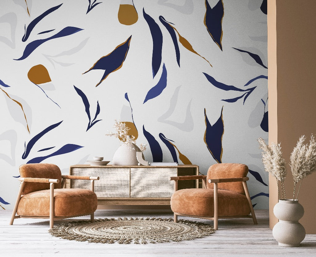 A stylish living room with a beige sofa and two caramel leather armchairs, against a wall featuring a large, Decor2Go Wallpaper Mural in blues and golds. A round rug and a vase with dried