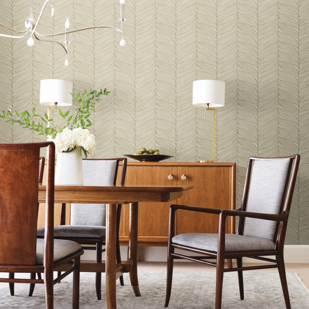 Dining Room - A wooden set is enhanced by the Modern Metals Collection, with a metallic finish on the sideboard hosting flowers and lamps. A unique light fixture adds charm, while York Wallcoverings' Neutral & Gold Luminous Leaves Wallpaper subtly accents the room's decor