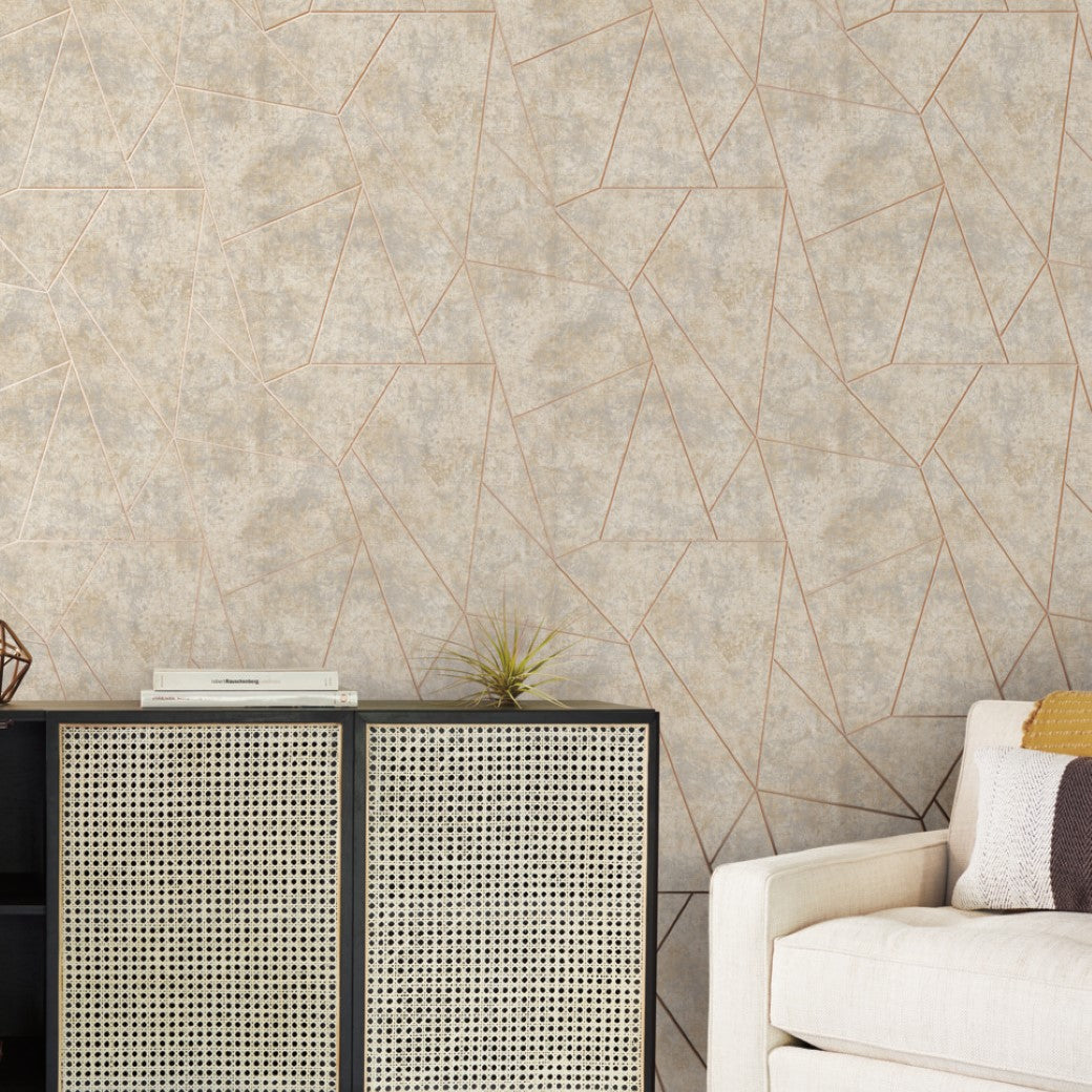 Living Room - A modern features York Wallcoverings' Neutral & Gold Nazca Wallpaper. A light sofa with a striped pillow sits on the right, while a black console with a rattan front and metallic finish stands against the wall, adorned with a small plant