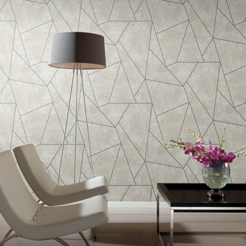 Living Room - A modern features two white chairs, a tall floor lamp with a gray shade, and a black coffee table with purple flowers. The backdrop is Neutrals & Gold Metallic Cascade Wallpaper by York Wallcoverings, enhancing elegance with neutral tones