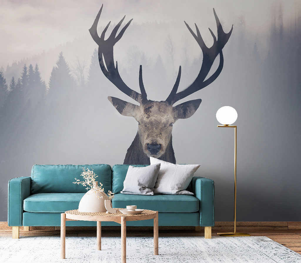 A stylish living room featuring a large Oh Deer! Wallpaper Mural of a stag's head on the wall above a teal sofa, with a small wooden coffee table and a modern floor lamp beside it.