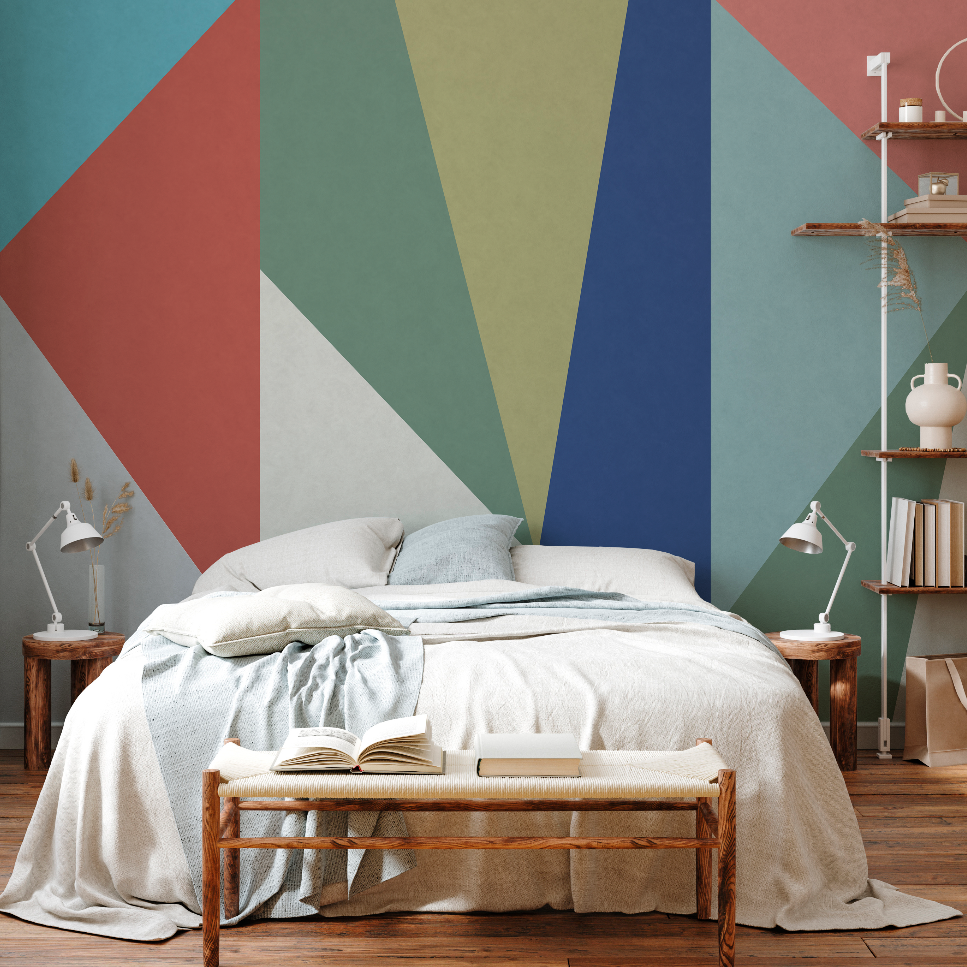 A modern bedroom featuring a large bed with white bedding, a rustic wooden bench at its foot with open books, and a vibrant Decor2Go Wallpaper Mural on the wall.