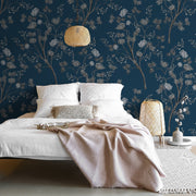 Bedroom - A serene bedroom featuring a low bed with white bedding and a soft pink throw, against a Decor2Go Wallpaper Mural. A woven pendant light and a rattan nightstand add a natural touch.