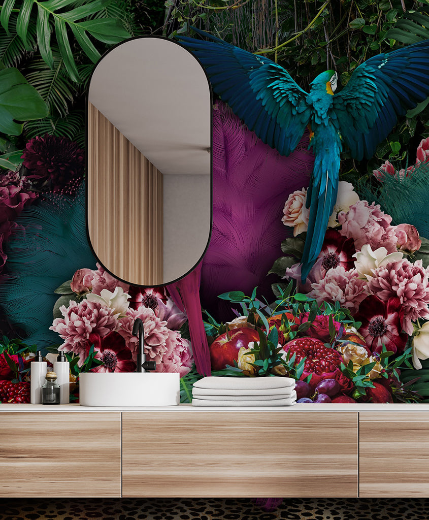 A vibrant indoor scene with a Parrot Paradise Wallpaper Mural by Decor2Go atop a wooden cabinet surrounded by lush, colorful flowers and foliage in a tropical paradise mural. A vivid blue parrot is in mid-flight on the left side.