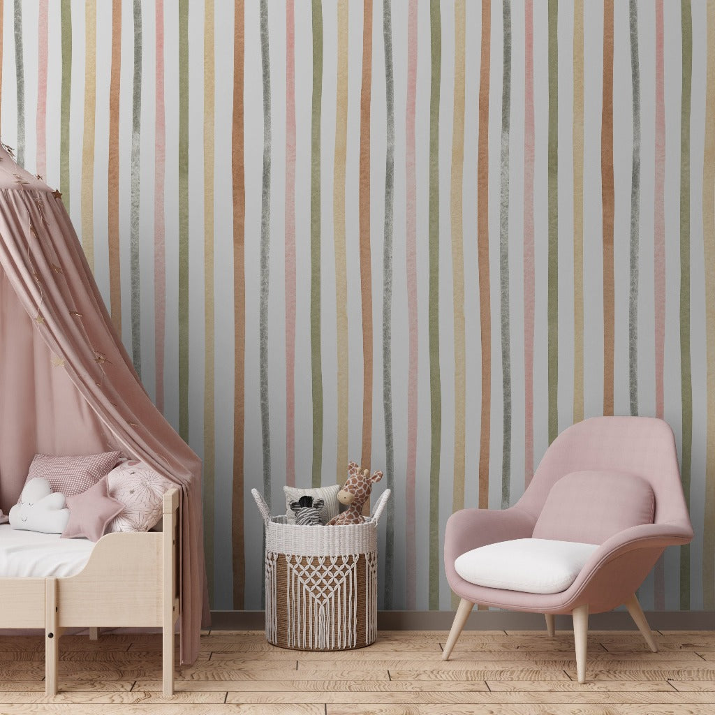 A cozy children's room with a pink canopy bed filled with cushions, next to a basket of toys and a pink armchair, against Decor2Go Wallpaper Mural's Pastel Perfection Wallpaper Mural.