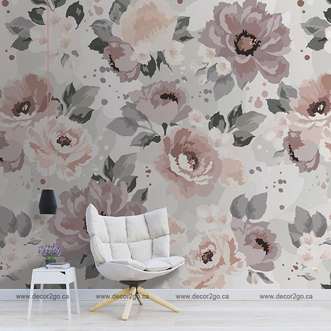 A contemporary living space featuring a wall adorned with a large Decor2Go Wallpaper Mural in soft pink, grey, and cream hues. The room includes a stylish white chair, a small side table, and