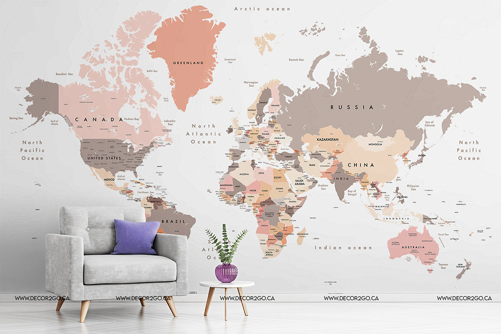 A minimalist living room with a stylish armchair and a side table, both beside a large wall decorated with Decor2Go Wallpaper Mural's Peach World Map Wallpaper Mural.