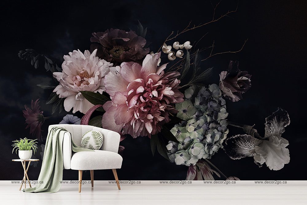 A stylish room featuring the Decor2Go Wallpaper Mural Peonies Over Black on a dark wall, an armchair with a green throw and cushion, and a small white side table with a plant.