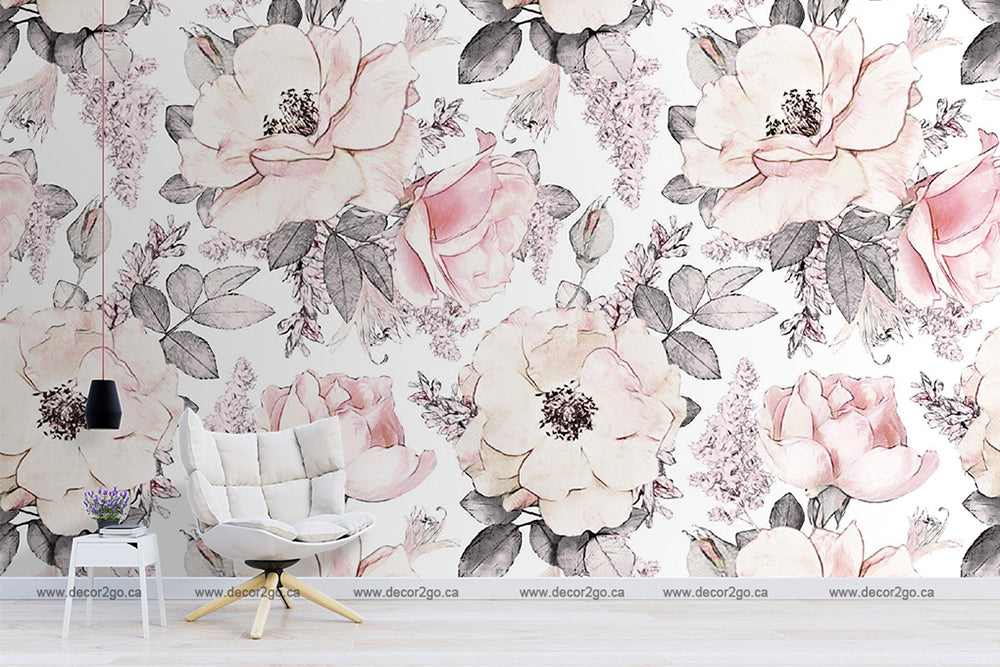 A modern living room with a Decor2Go Wallpaper Mural featuring large pink roses and grey leaves. There is a stylish white armchair and a small side table with a vase of flowers, embody.