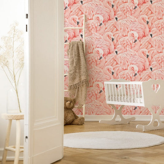 A cozy nursery room with a Decor2Go Wallpaper Mural Pink Flamingos mural, featuring a white crib and a rocking horse on a round rug, with soft natural lighting and an open door.