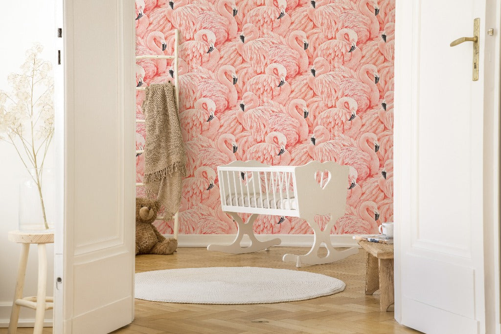 A cozy nursery room with a Decor2Go Wallpaper Mural Pink Flamingos mural, featuring a white crib and a rocking horse on a round rug, with soft natural lighting and an open door.