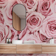 Bathroom - A stylish bathroom featuring a feature wall covered in large Pink Paradise Wallpaper Mural from Decor2Go Wallpaper Mural with a wooden vanity, white basin, oval mirror, and neatly arranged toiletries and towels.