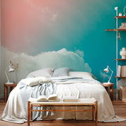 Bedroom - A serene bedroom with a large bed covered in light gray linens, a book open on a wooden bench at the foot of the bed, against a vibrant Decor2Go Wallpaper Mural transitioning from blue to