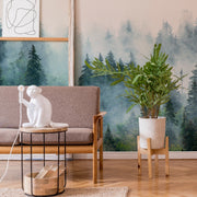Living Room - A cozy living room corner featuring a grey sofa with a white monkey-shaped lamp on an adjacent table, a plant in a concrete planter, local craftsmanship wooden stool, and a Decor2Go Wallpaper Mural of Reaching Tree Tops.