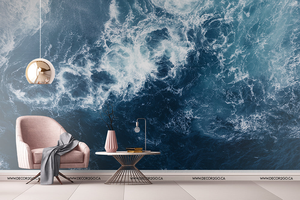 Living Room - A stylish living room with a plush pink armchair and a small coffee table under a hanging lamp, against a Decor2Go Wallpaper Mural of Realm of Poseidon swirling ocean waves.