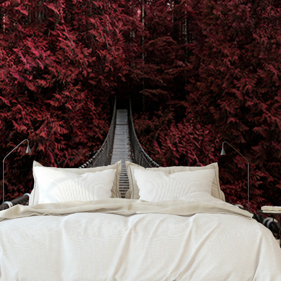 A bedroom with a large Decor2Go Wallpaper Mural depicting a path surrounded by vibrant crimson foliage. The room features a double bed with white bedding in the foreground.