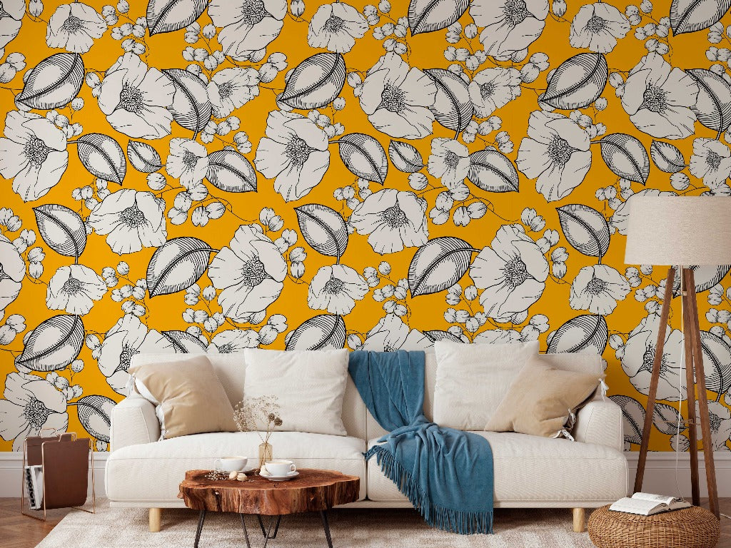 Living Room - A cozy living room with a white sofa adorned with a blue throw blanket, a wooden coffee table, and a lamp, against Decor2Go Wallpaper Mural adorned with large white floral patterns.