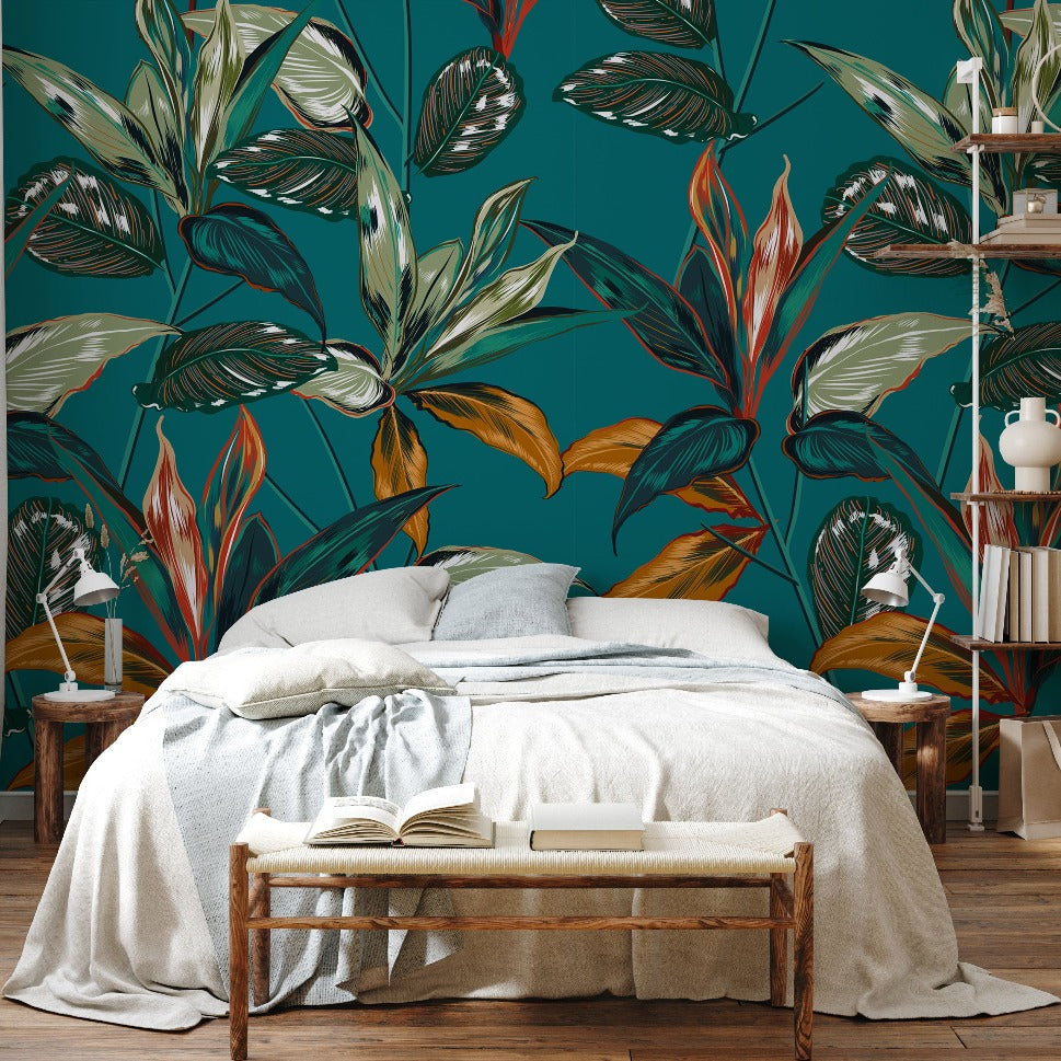 A cozy bedroom featuring a large bed with white bedding, a wooden bench with an open book at the foot of the bed, and walls decorated with Decor2Go Retro Tropical Botanical Pattern Wallpaper Mural.