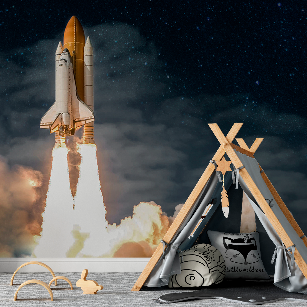 A digital composite image with a Rocket to the Moon Wallpaper Mural by Decor2Go Wallpaper Mural in the background and a child's play area featuring a teepee, plush cushions, and wooden toys in the foreground under a starry sky.