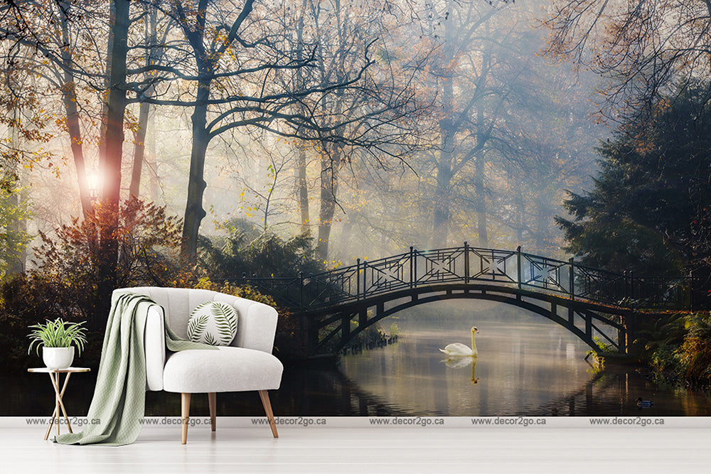 Living Room - A serene living room setup with a modern white chair and a green blanket next to a small table with plants, all overlaid on Decor2Go Wallpaper Mural featuring Romantic Bridge Wallpaper Mural scene with a bridge over a misty forest.