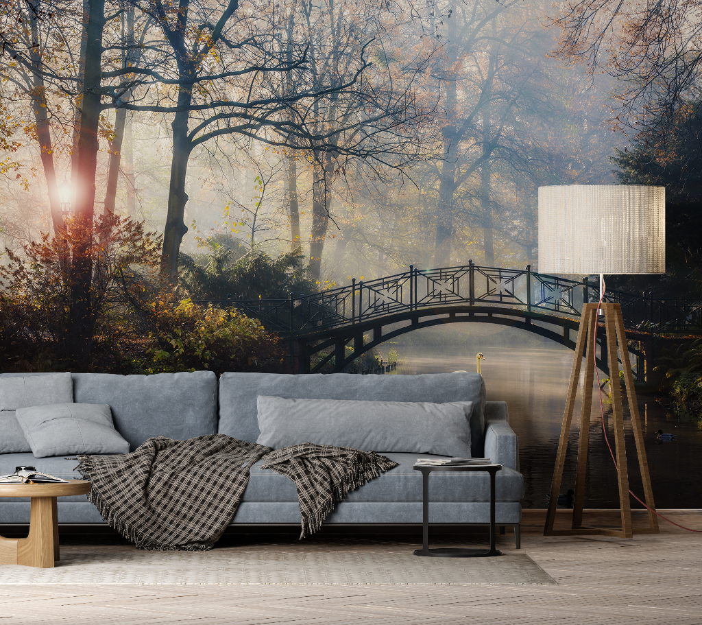 Living Room - A cozy living room featuring a gray sofa with a plaid throw, a floor lamp, and a side table, with a Decor2Go Wallpaper Mural of the Romantic Bridge in autumn on the wall.