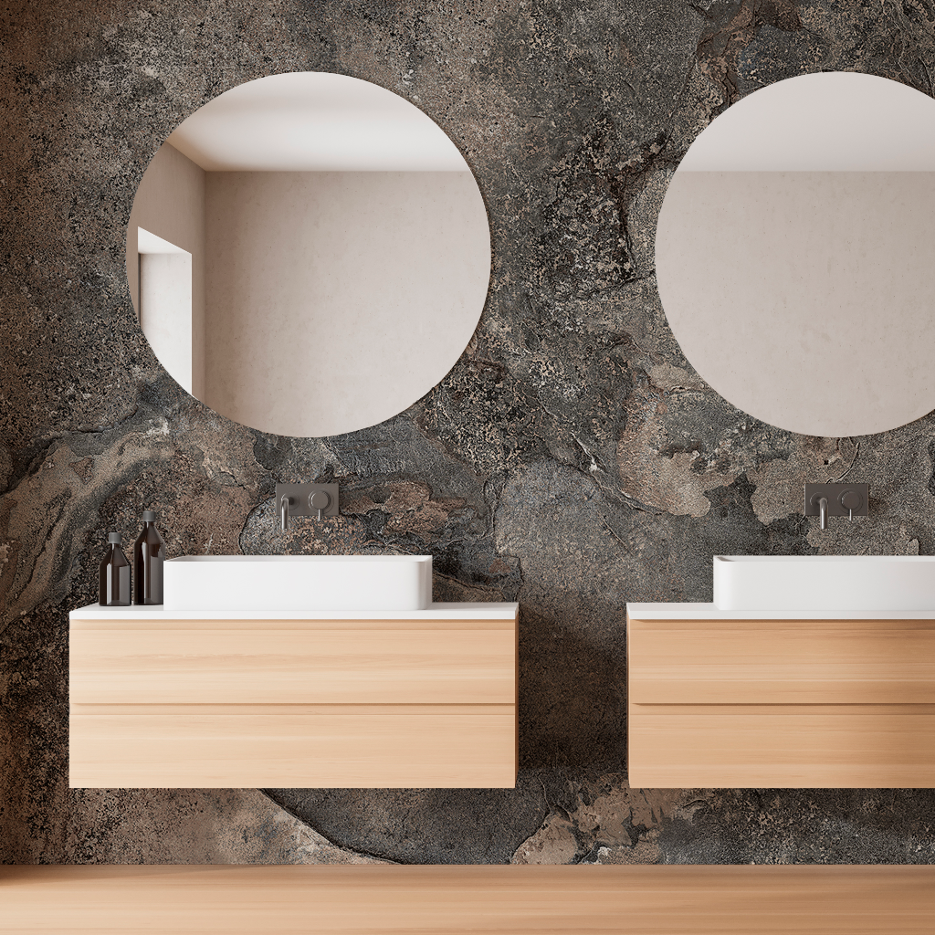 Bathroom - Two modern wooden bathroom vanities with brilliant white countertops against a Decor2Go Wallpaper Mural, each featuring a round mirror and minimalist faucets. Small toiletry items are neatly arranged on the counters.
