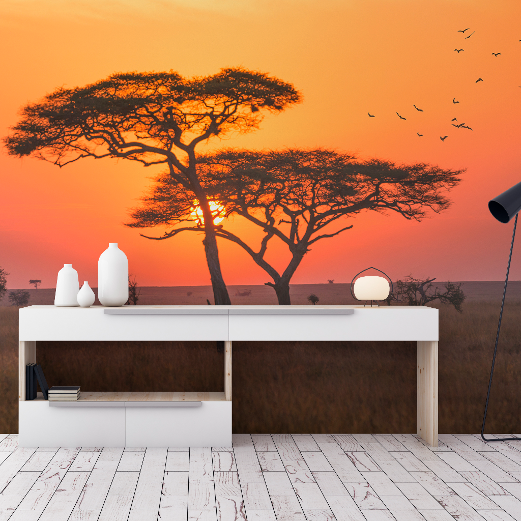 A modern bedroom interior with a large Decor2Go Wallpaper Mural featuring acacia trees and flying birds, a stylish desk with decor, and a white floor.