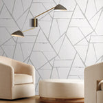 Living room furniture with a modern design, warm light and geometric lines wallpaper