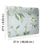 A roll of **Springtime Midnight/Multi Wallpaper Black, Blue (60 Sq.Ft.)** by **York Wallcoverings** featuring a light blue background adorned with green leaves and white flowers. This springtime removable wallpaper measures 27 feet (8.23 meters) in length and 27 inches (68.58 centimeters) in width, ensuring easy installation for any room transformation.