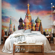 Bedroom - A cozy bedroom with natural wood floors and a large bed covered with a beige comforter. A vibrant, custom-sized Decor2Go Wallpaper Mural of St. Basil's Cathedral in Moscow dominates the room, adding a colorful