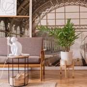 Living Room - A cozy living room with a gray sofa, a white monkey-shaped lamp on a side table, a large potted plant, and a unique Decor2Go Wallpaper Mural.