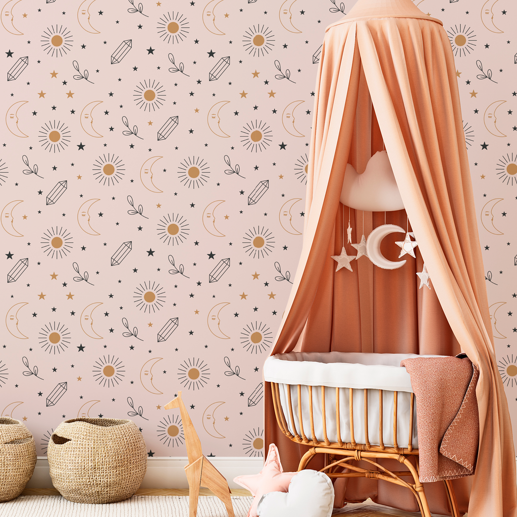 A cozy nursery corner featuring a draped peach canopy over a white bassinet, set against Decor2Go Wallpaper Mural's Sun and Moon Wallpaper Mural. Two woven baskets and soft toys complement the warm ambiance.