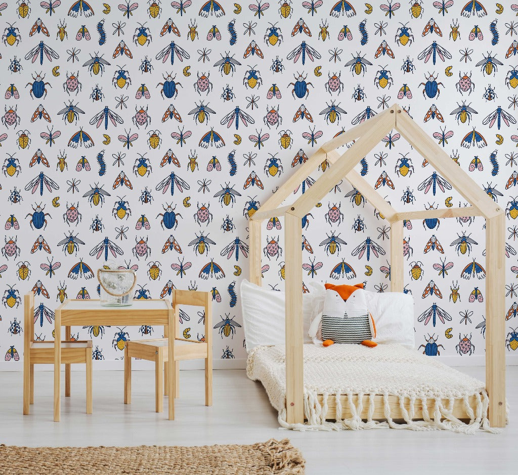 Kids Room - A children's room with a house-shaped bed frame, a small wooden desk and chair, and a colorful Decor2Go Wallpaper Mural. A rug and scattered cushions complete the cozy space.