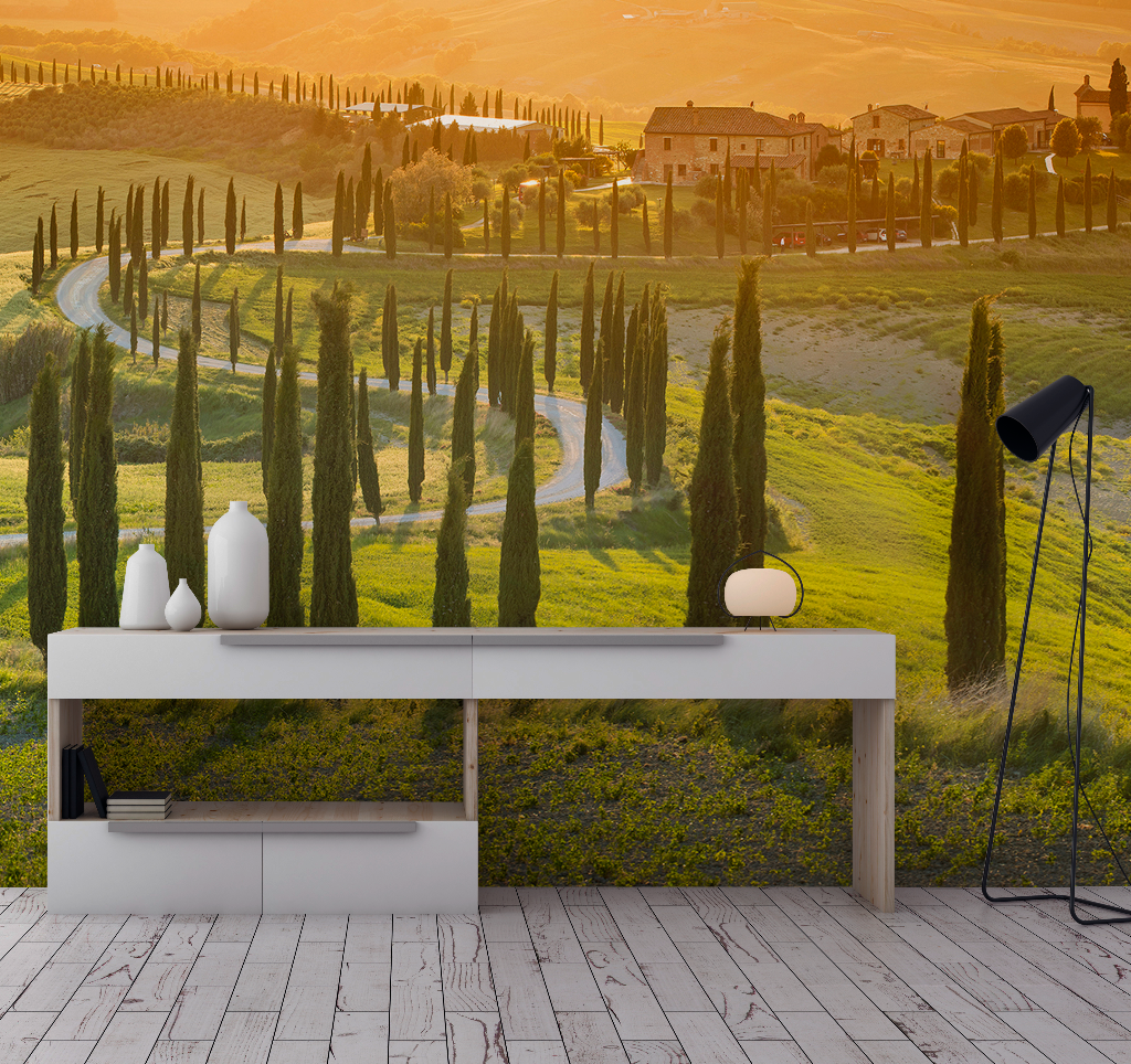 Living Room - A modern living room with a white console table, featuring a lamp and vases, overlooking a large wall image of the vibrant green hills of Decor2Go Wallpaper Mural with rolling hills and a winding road