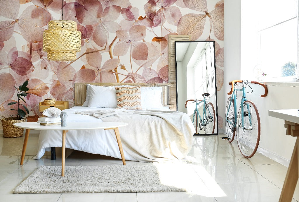 Bedroom - Bright bedroom with a large bed, white linens, and a Translucid Flowers Wallpaper Mural by Decor2Go Wallpaper Mural. A bicycle is parked beside a full-length mirror. Sunlight floods in through a large window.