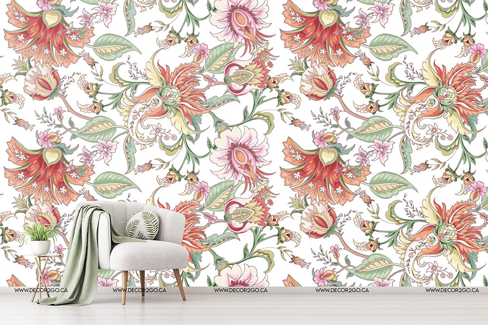 Living Room - A modern living room featuring a Decor2Go Wallpaper Mural with a mix of green, pink and orange hues. A stylish gray armchair with a green pillow is placed beside a draped gray blanket.