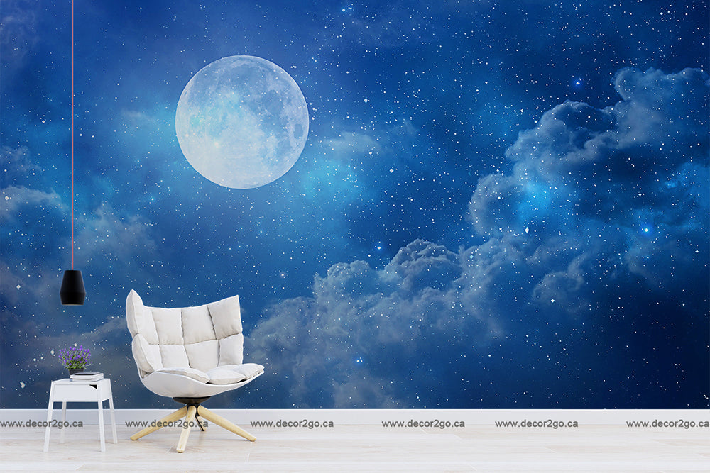 Modern interior with a white armchair, a small table, and a hanging lamp against a Decor2Go Wallpaper Mural depicting a starry night sky and a large moon.
