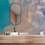 A modern bathroom vanity with a wooden countertop, white basin, and black faucet. The wall features a Decor2Go Wallpaper Mural. A mirror and neatly arranged toiletries complete the scene.