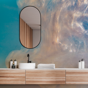 Bathroom - A modern bathroom vanity with a wooden countertop, white basin, and black faucet. The wall features a Decor2Go Wallpaper Mural. A mirror and neatly arranged toiletries complete the scene.