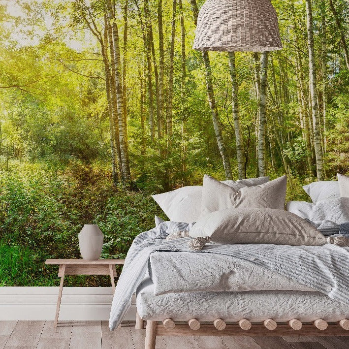 Bedroom - A serene bedroom with a large bed covered with gray and white bedding, a small wooden bedside table, and a modern hanging lamp, seamlessly blending with a vibrant forest background featuring a Decor2Go Wallpaper Mural illuminated by Urban Picasso Wallpaper Mural.