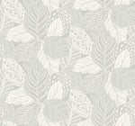 A seamless pattern featuring a collection of intricately designed leaves in various shades of gray envelops this Vinca Glint Wallpaper Metallic (60 Sq.Ft.). Each leaf exhibits unique patterns with dots, lines, and geometric shapes, creating a harmonious texture. The background is a soft, off-white color. This product is offered by York Wallcoverings.