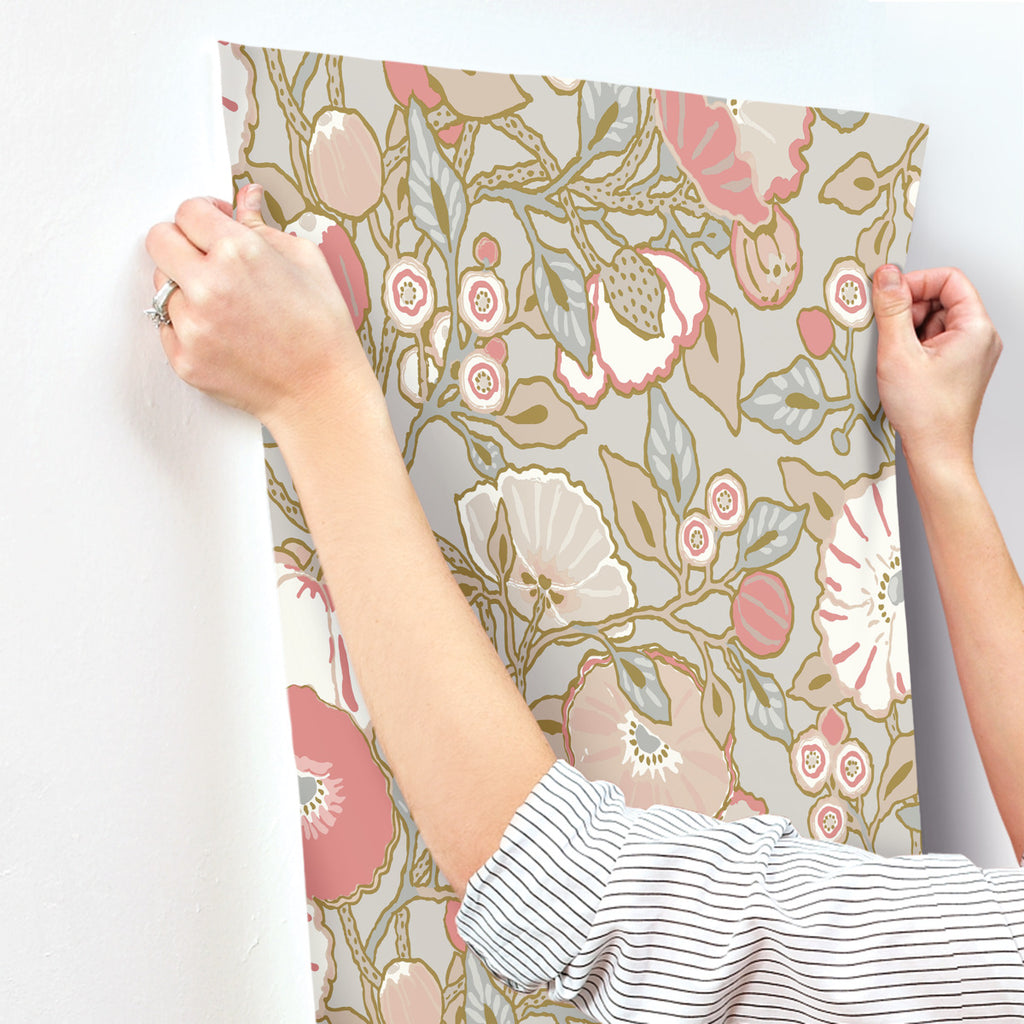 Grey pink floral wallpaper hanging on the wall