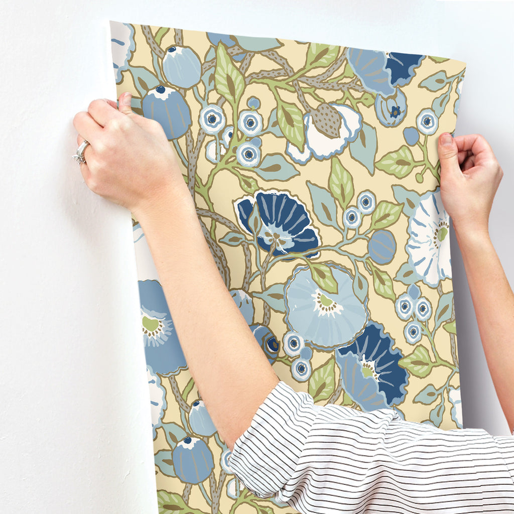Yellow blue floral wallpaper hanging on the wall