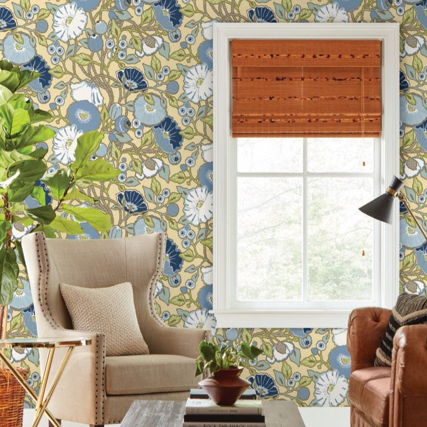 yellow blue floral wallpaper on the wall, beautiful beige chair and brown leather sofa