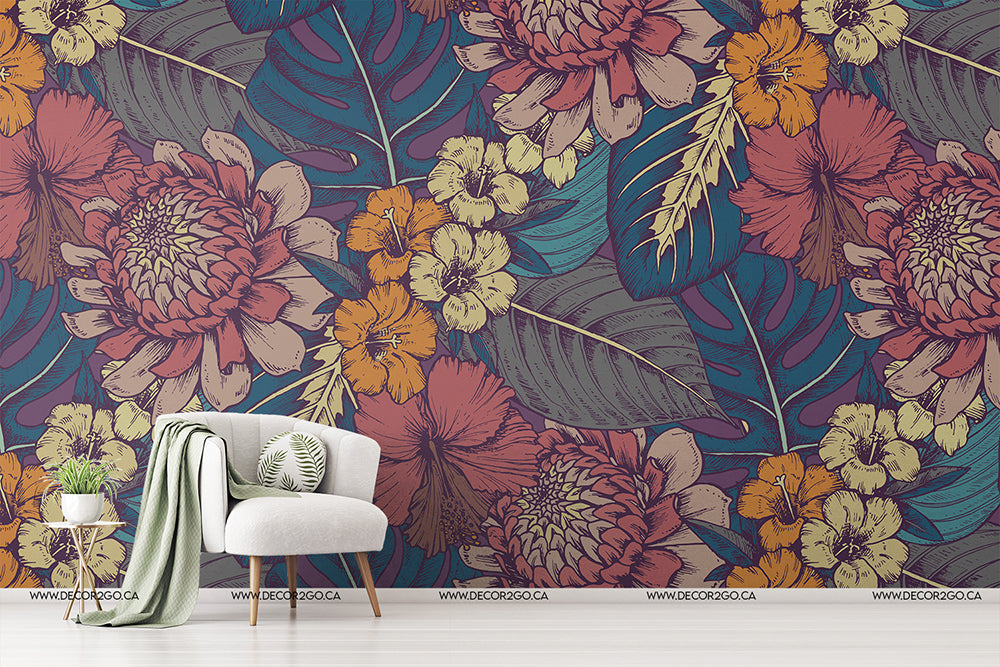 A stylish room corner featuring Decor2Go Wallpaper Mural with tropical flowers, complemented by an elegant white chair, a green throw, and a small plant on a stool.
