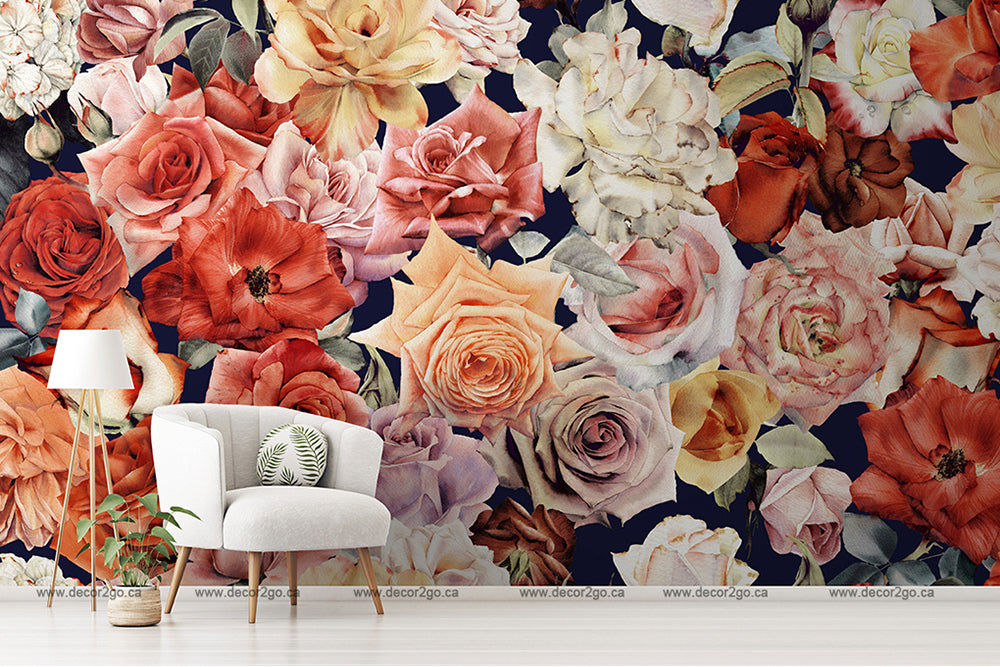 A stylish interior room with a white armchair, a small plant on its side, and a floor lamp, against an elegant Wall of Roses Wallpaper Mural featuring large crimson and cream roses from Decor2Go Wallpaper Mural.