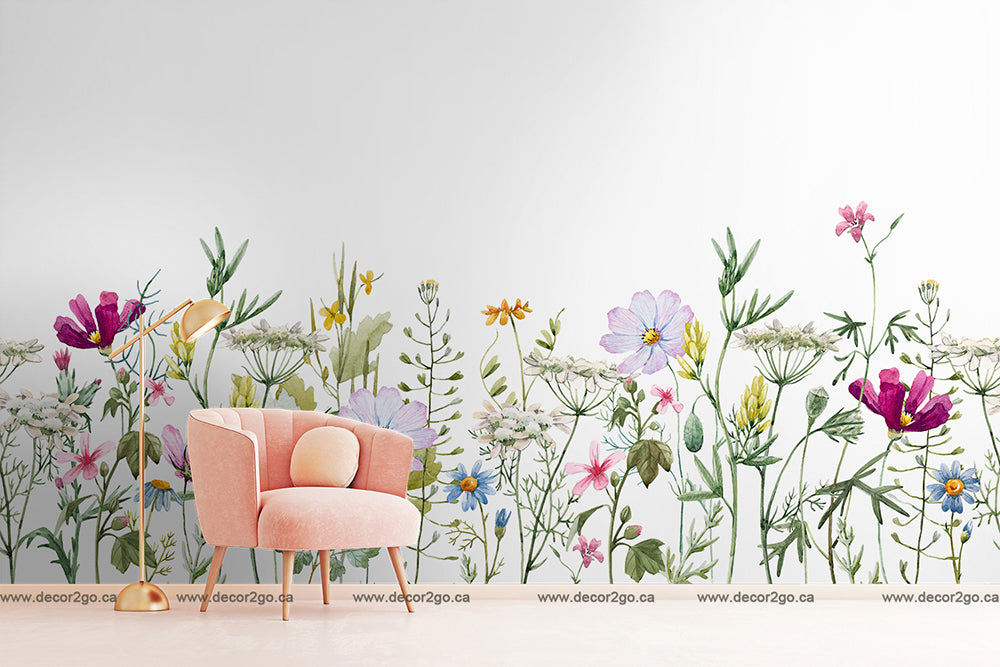 A modern pink armchair in a simple white living space with a wall decorated with a Decor2Go Wallpaper Mural featuring lifelike illustrations of various colorful flowers.