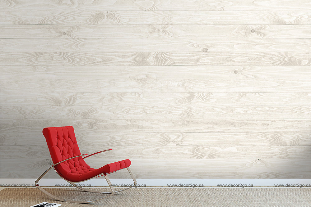 A minimalist room with a Decor2Go Wallpaper Mural White Wood wallpaper mural and a bright red modern rocking chair positioned in the center, set against a plain white floor.