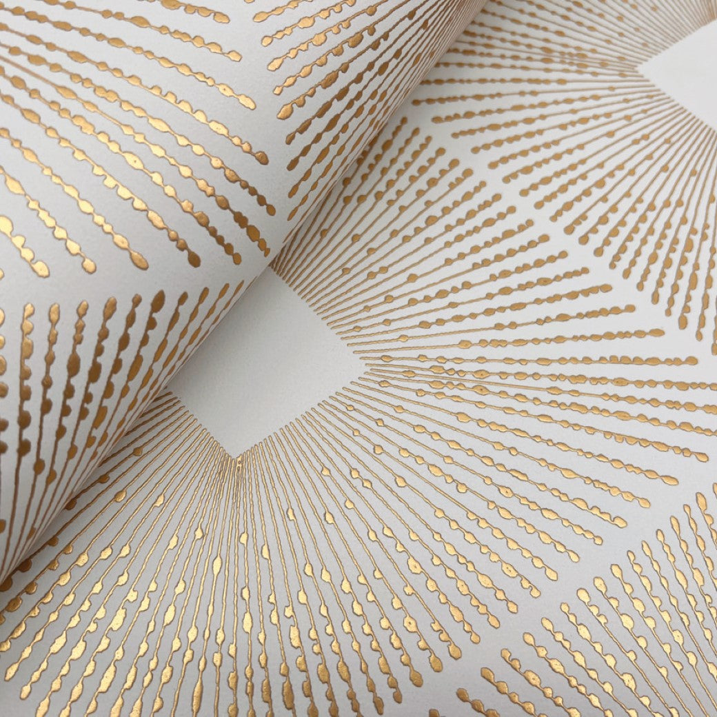 A close-up of York Wallcoverings' White & Gold Harlowe Wallpaper (57 SqFt) highlights a gold geometric sunburst pattern on white, with intricate metallic designs featuring symmetrical lines radiating outwards, creating a sophisticated and elegant effect ideal for modern spaces.