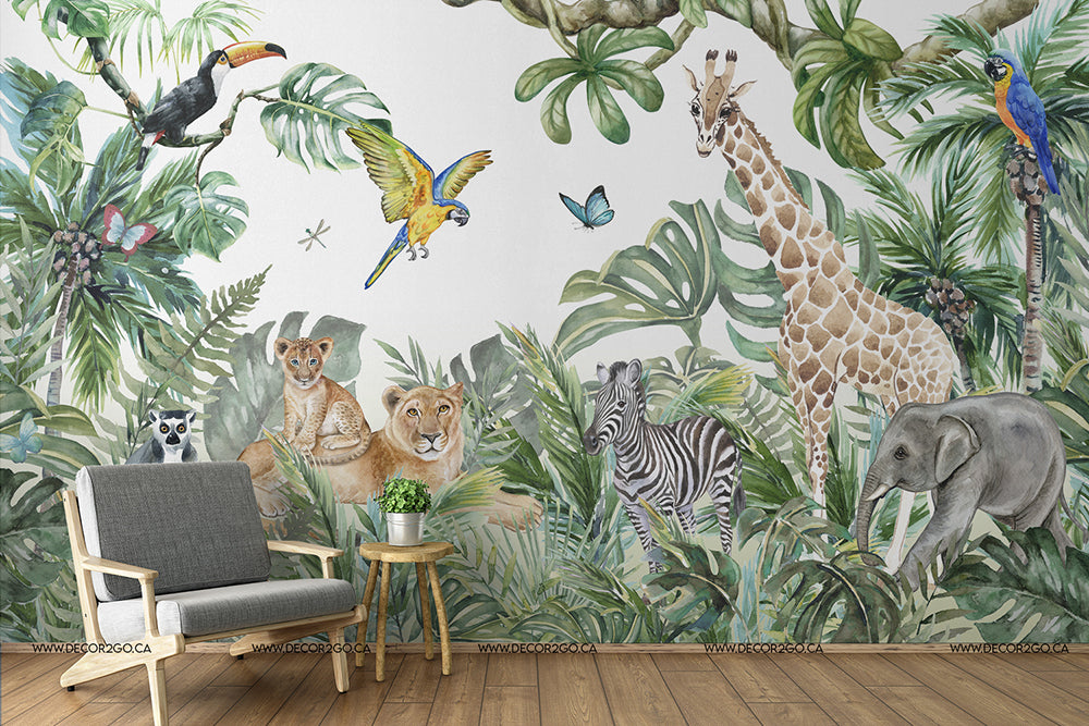 A cozy room corner with a stylish chair and side table against a vibrant kids room mural of jungle animals, including a giraffe, zebra, elephant, and exotic birds among lush greenery featuring the Wild Animals and the Jungle Watercolor Mural Wallpaper from Decor2Go Wallpaper Mural.